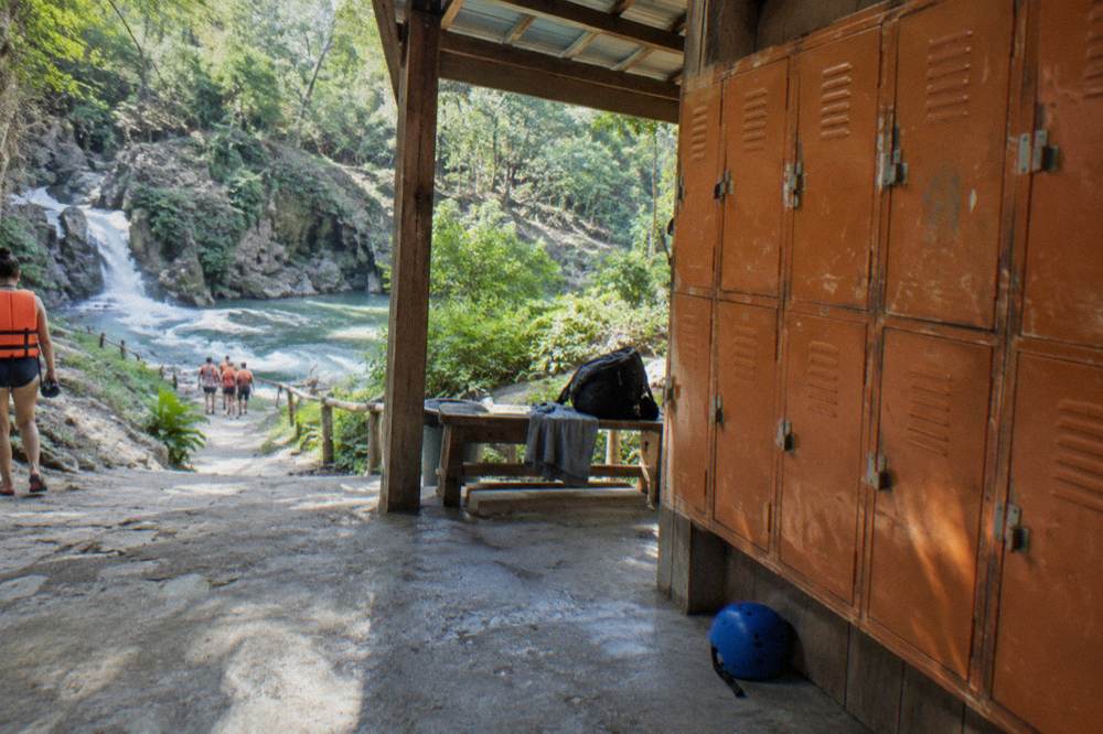 Rows of orange lockers along a wooden wall at an outdoor visitor center