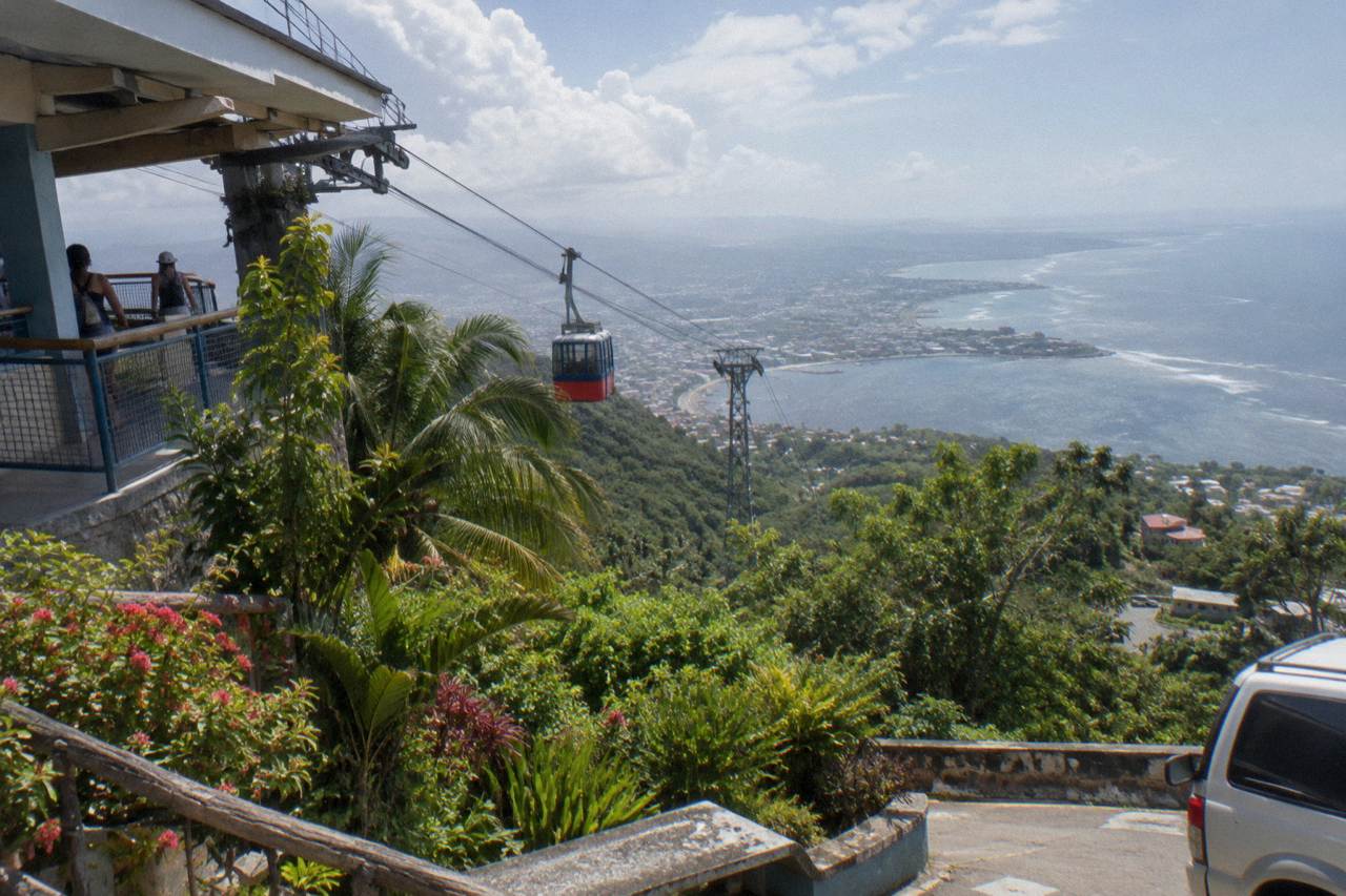 Cable car cabin above Puerto Plata on Isabel de Torres, green hillside, botanical gardens and the bay far below