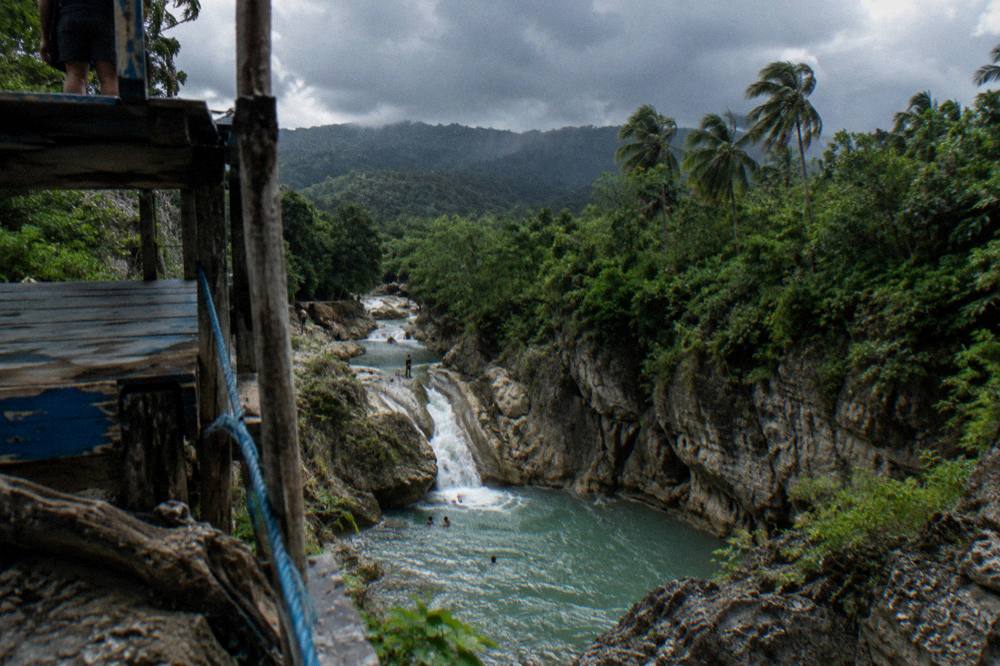 Rain clouds over forested hills above the waterfall canyon
