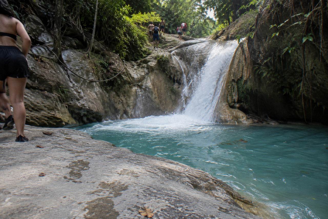 Turquoise pool at the base of a jungle waterfall in the Damajagua river canyon