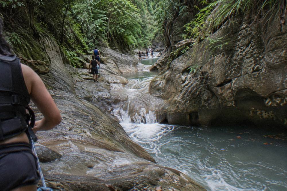 Canyon river winding between smooth rock walls with pools of clear water