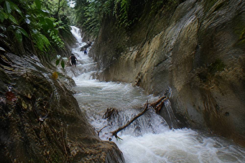 Narrow upper canyon section with cascading white water between high rock walls