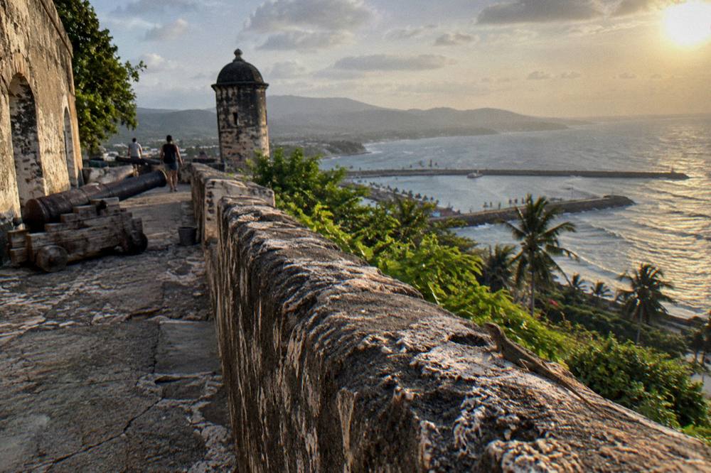 Coastal road at golden hour near Puerto Plata with the sea on the horizon