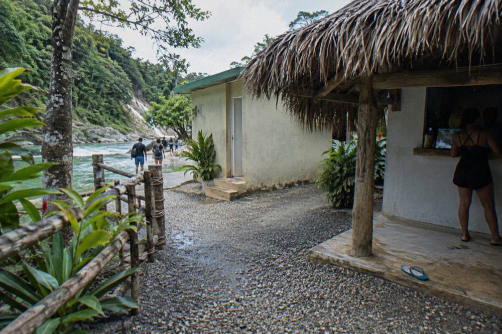 Small ticket window and thatched visitor centre building at the entrance to the waterfalls