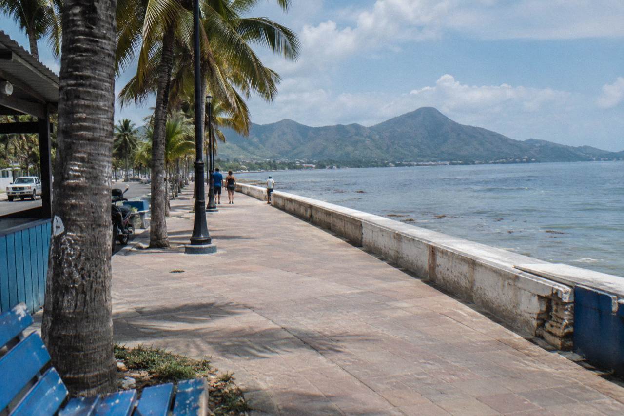 Wide oceanfront promenade in Puerto Plata with palm trees and calm morning light