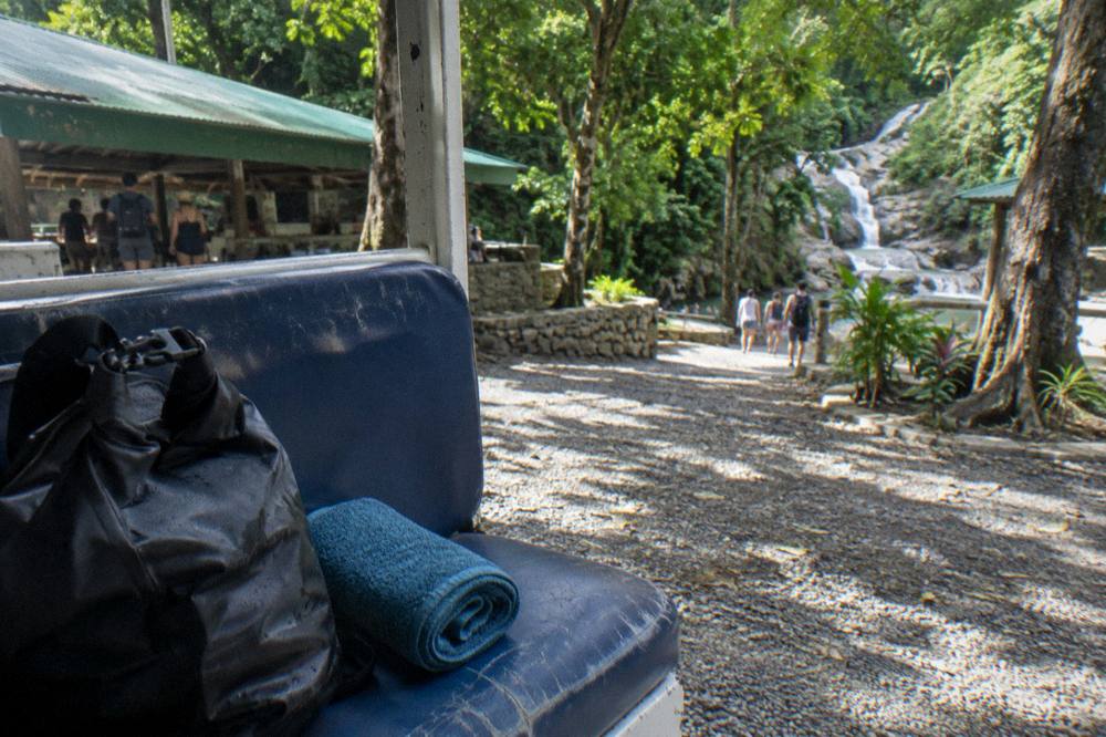 A packed dry bag and towel resting on a bus seat before a canyon tour